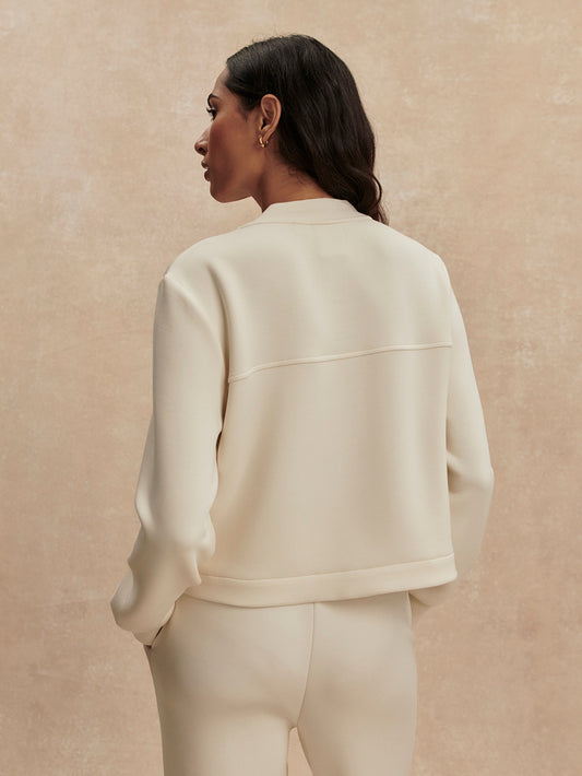 round neck soft sweat jacket with 2 flap pockets and large cream buttons from varley rear view