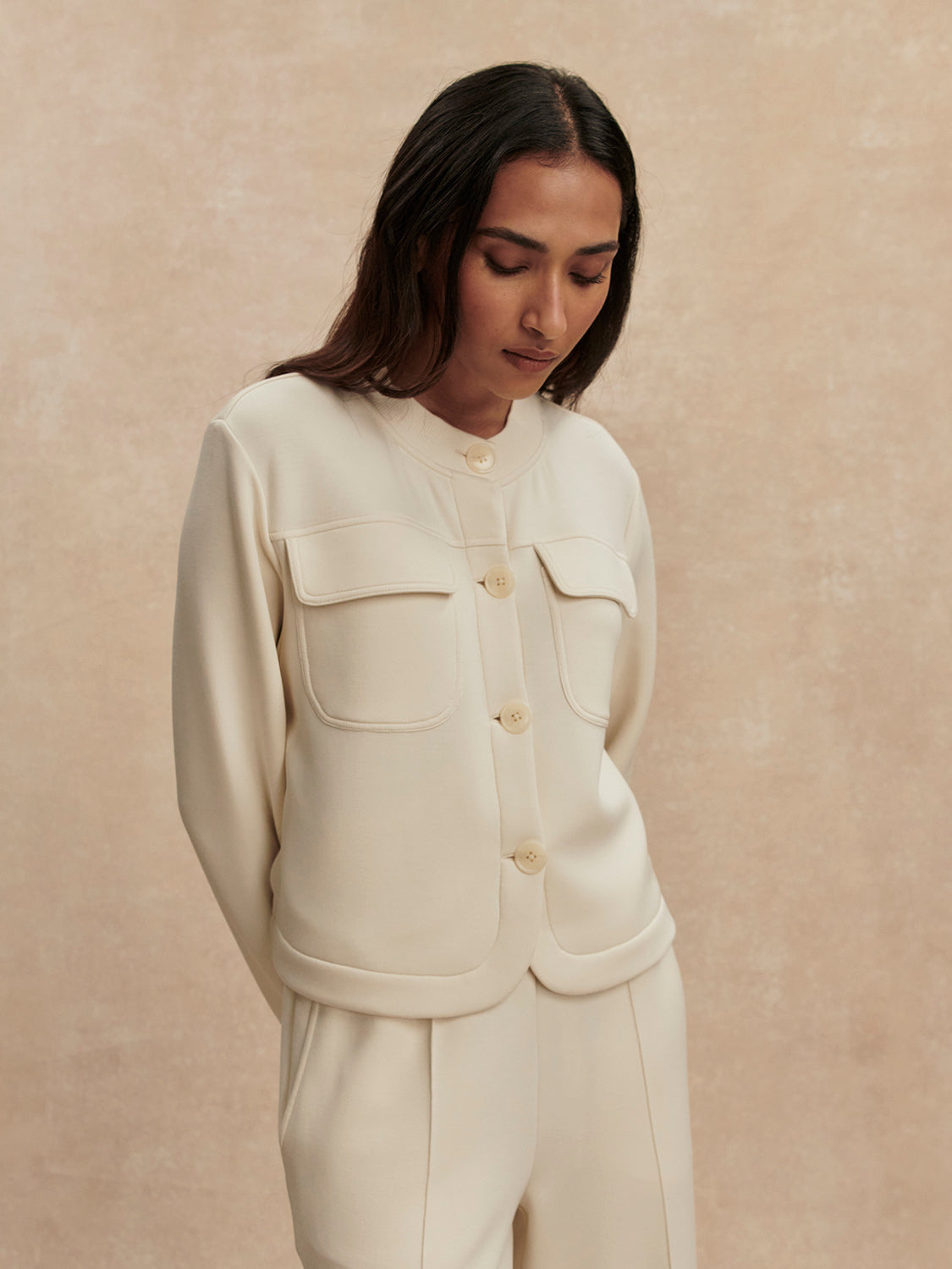 round neck soft sweat jacket with 2 flap pockets and large cream buttons from varley