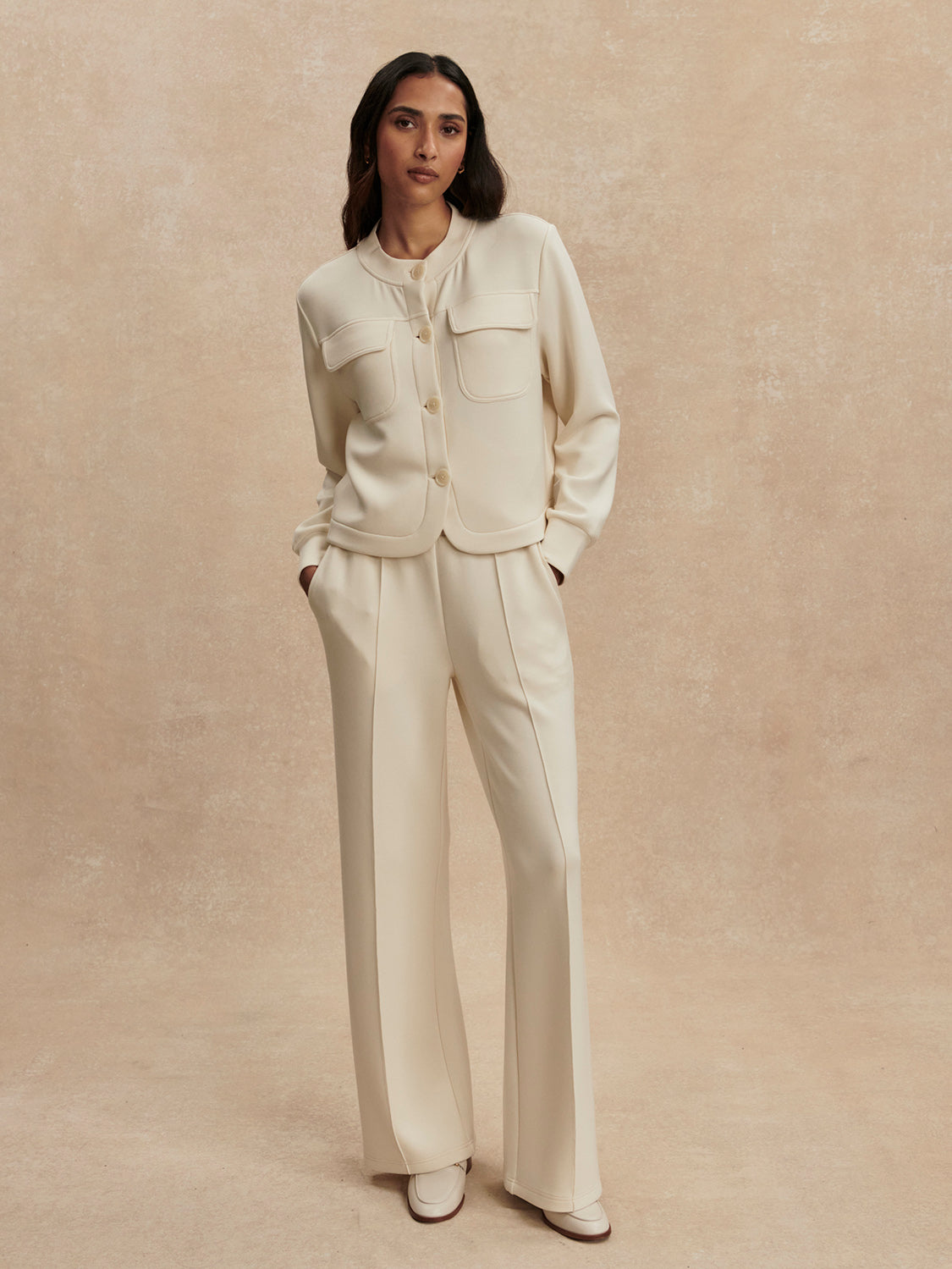 round neck soft sweat jacket with 2 flap pockets and large cream buttons from varley model shot