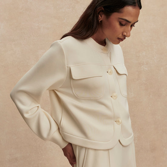 round neck soft sweat jacket with 2 flap pockets and large cream buttons from varley side view