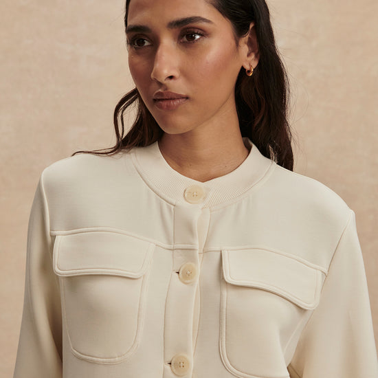 round neck soft sweat jacket with 2 flap pockets and large cream buttons from varley close up