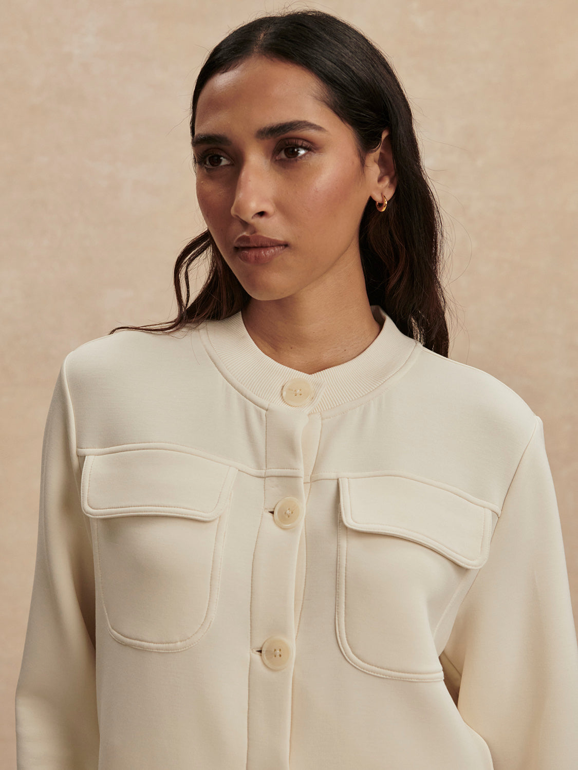 round neck soft sweat jacket with 2 flap pockets and large cream buttons from varley close up