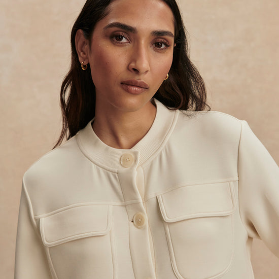 round neck soft sweat jacket with 2 flap pockets and large cream buttons from varley close up