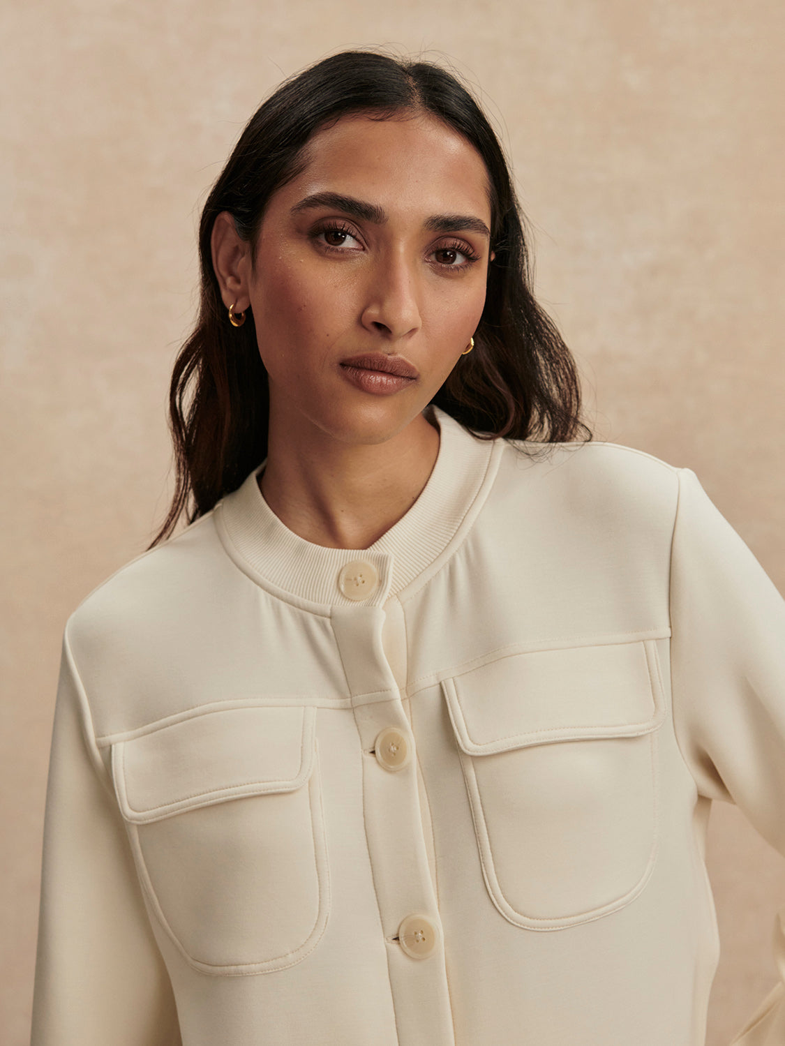 round neck soft sweat jacket with 2 flap pockets and large cream buttons from varley close up