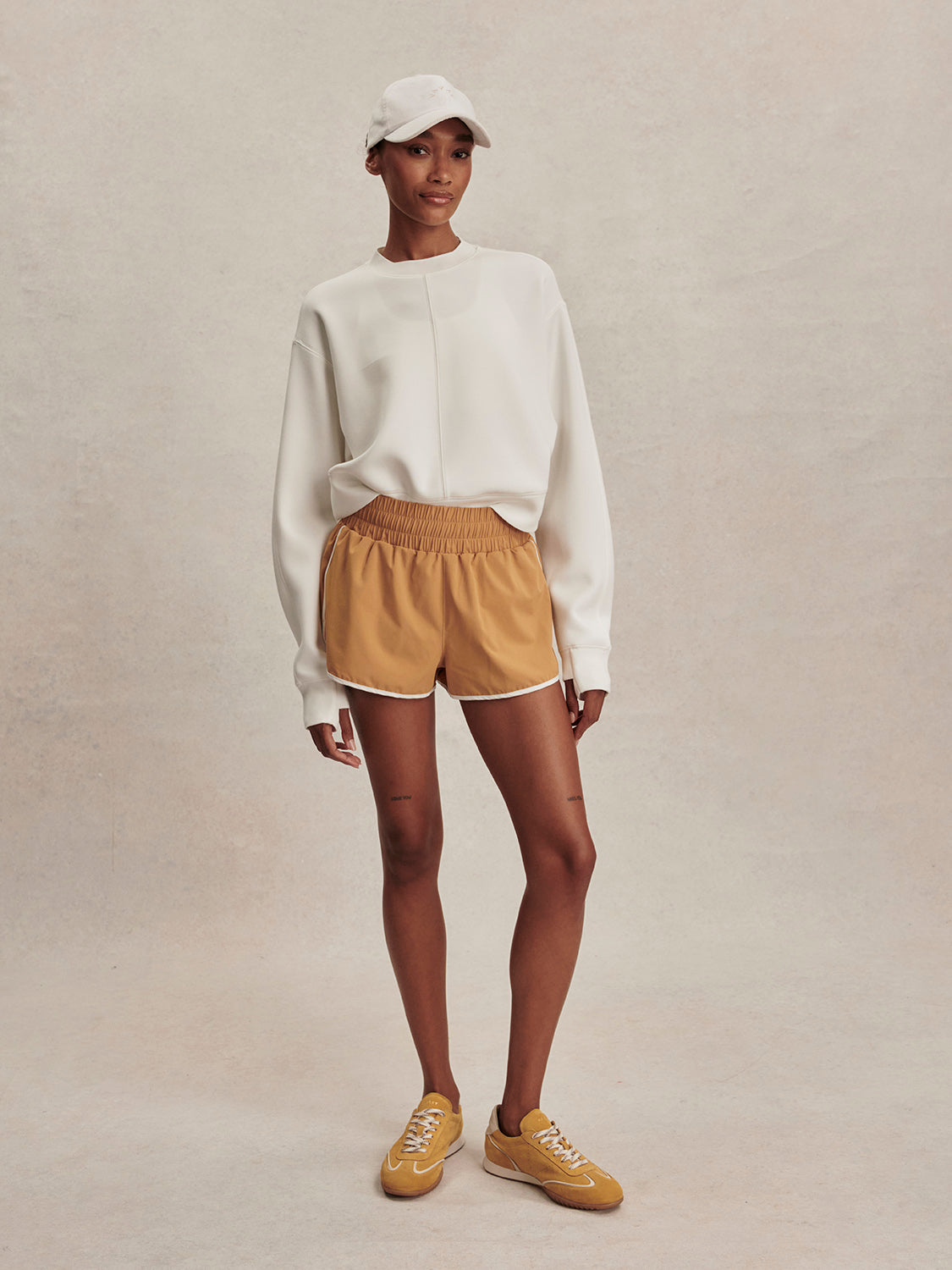 round neck ivory sweatshirt with piping down the centre from varley model shot