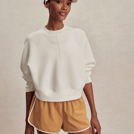 round neck ivory sweatshirt with piping down the centre from varley