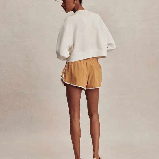 round neck ivory sweatshirt with piping down the centre from varley rear view