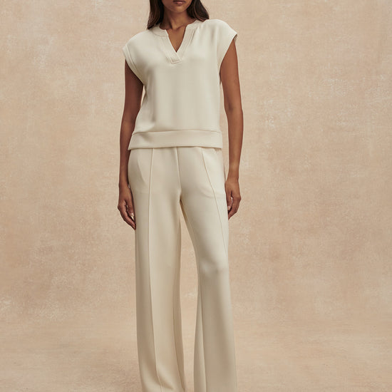 wide leg ivory sweat pants with central piping seam and elasticated waist from varley model shot