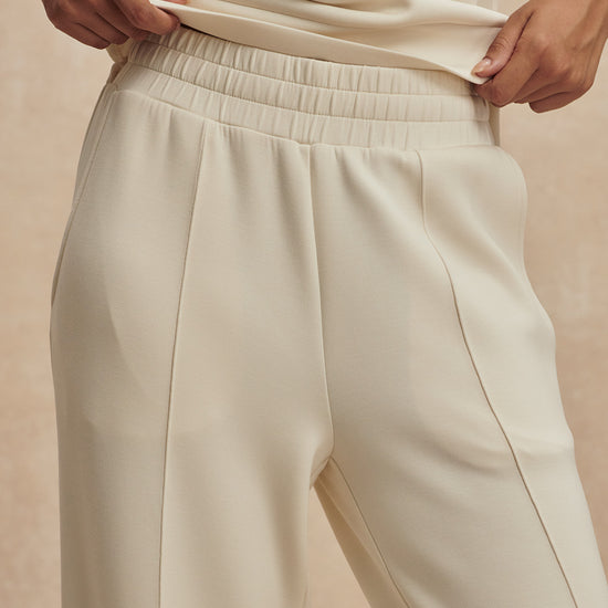 wide leg ivory sweat pants with central piping seam and elasticated waist from varley close up