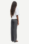 Person wearing a white top and gray pants on a white background rear view from Samsoe Samsoe