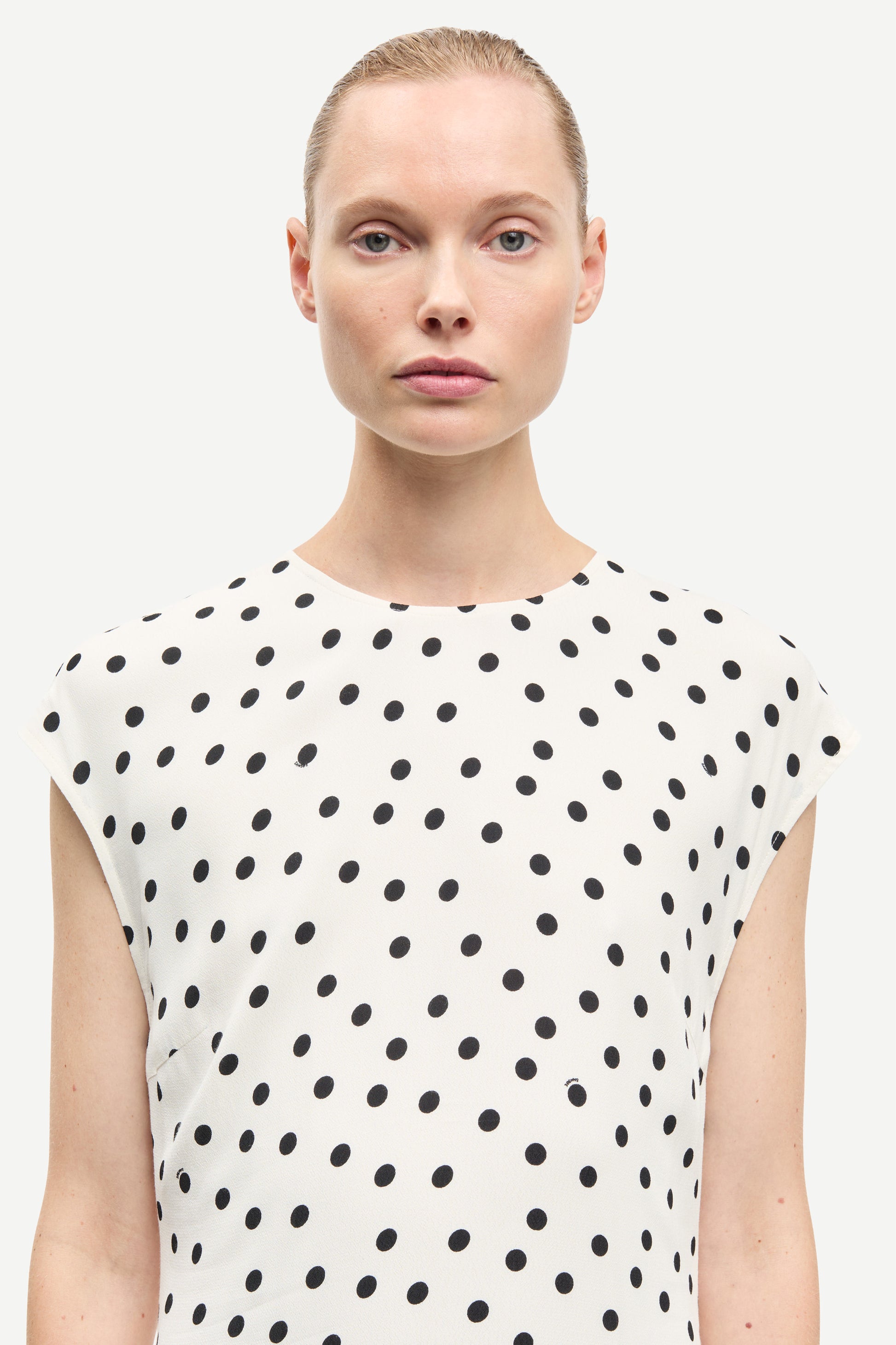 polka dot white mid length dress with cap sleeves and round neck from samsoe  close up