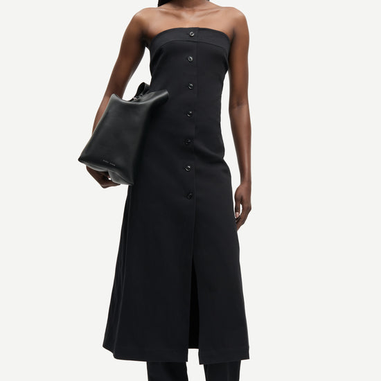 strapless mid length black dress with button down and a line shape from samsoe model shot