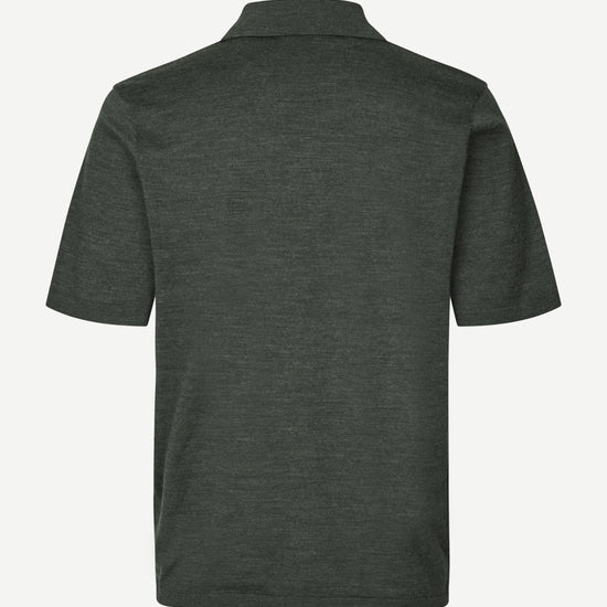 Dark green polo shirt on a white background