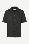 Black textured short-sleeve shirt on a white background from Samsoe Samsoe