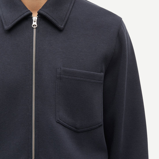 Navy blue jacket with a zipper and pocket on a white background