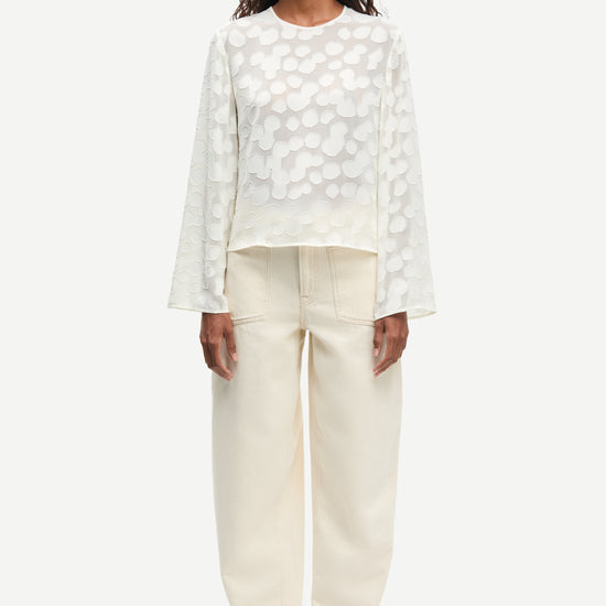 Front view of cream long sleeve top worn with cream trousers from Samsoe Samsoe