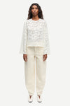 Front view of cream long sleeve top worn with cream trousers from Samsoe Samsoe