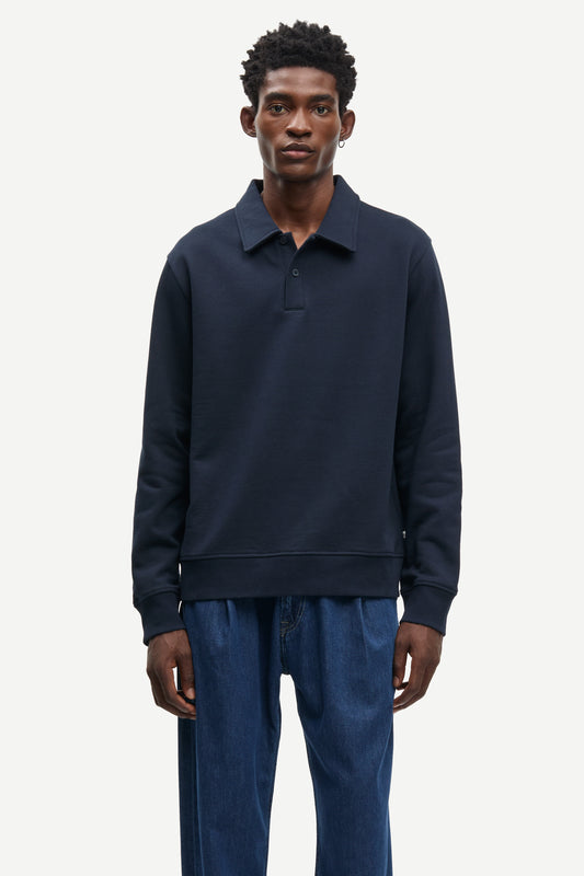 Man wearing a navy blue sweater and pants on a white background