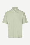 Light green polo shirt on a white background