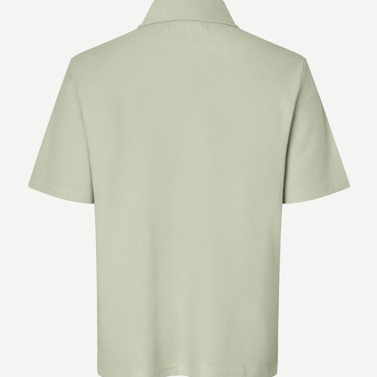 Light green polo shirt on a white background