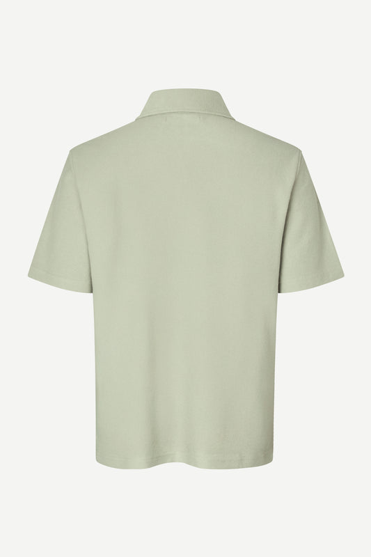 Light green polo shirt on a white background