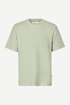 Light green t-shirt on a white background