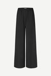 Black pants with subtle design on a light gray background