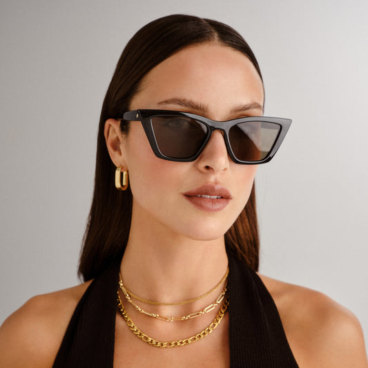 Black sunglasses by Le Specs on a female model, front view