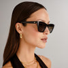 Black sunglasses by Le Specs on a female model, side view