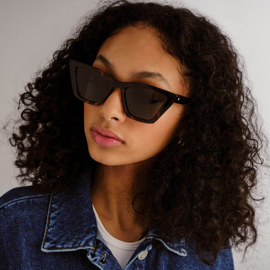 Tortoise shell Le Specs sunglasses on a female model front view