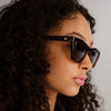 Tortoise shell Le Specs sunglasses on a female model, side view