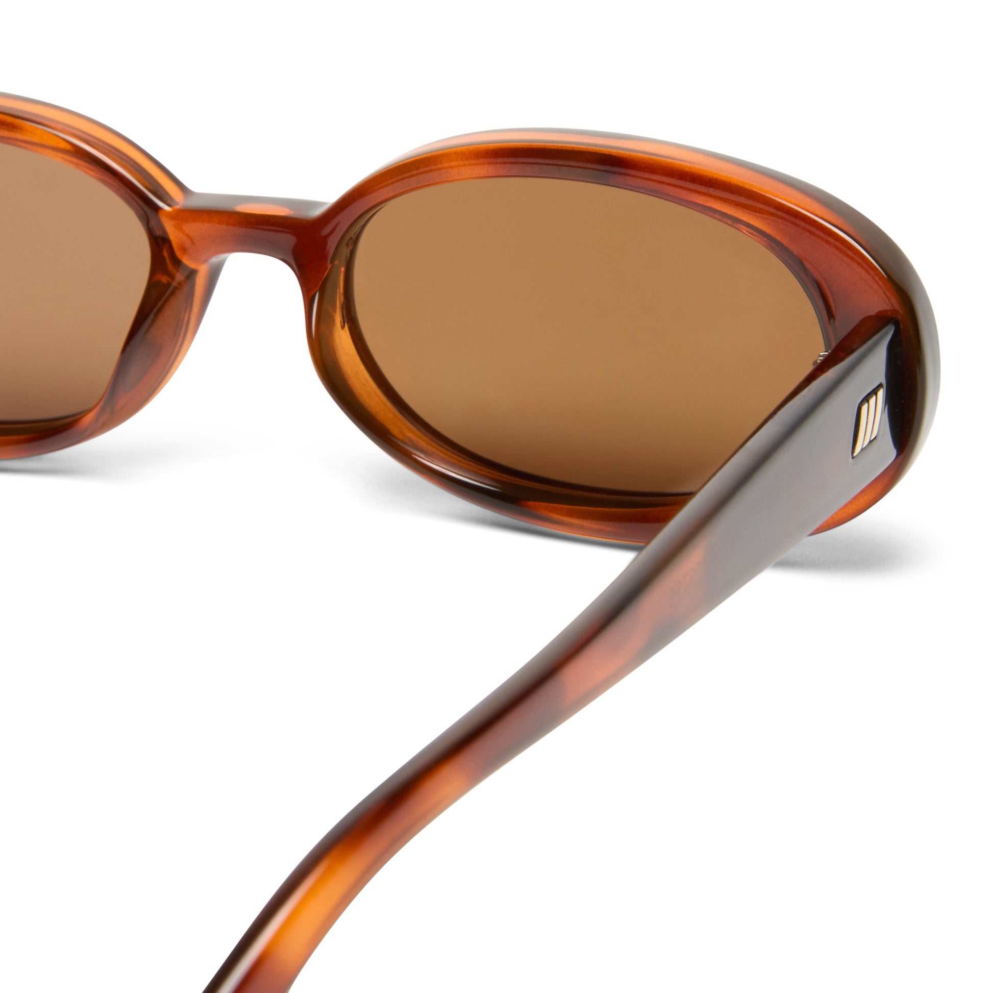tortoise shell Le Specs sunglasses on a white background close up