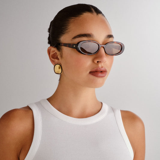 tortoise shell Le Specs sunglasses on a female model side view