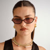 brown Le Specs sunglasses on a female model, front view