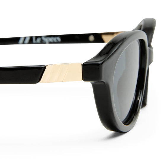 black Le Specs sunglasses on a white background close up