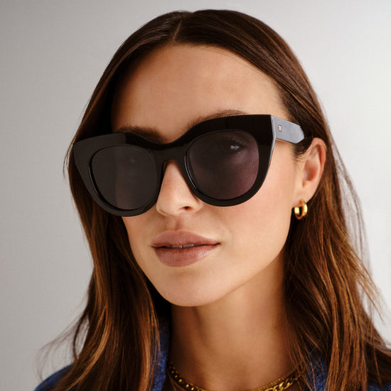 black Le Specs sunglasses on a female model front view