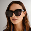 black Le Specs sunglasses on a female model front view