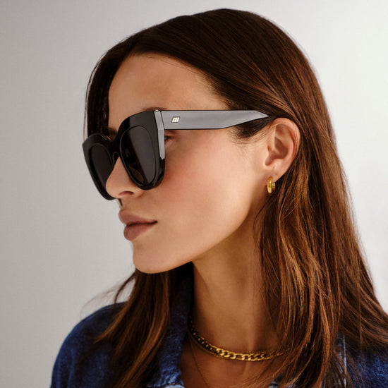 black Le Specs sunglasses on a female model side view