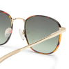Tortoise shell and gold Le Specs sunglasses on a white background close up