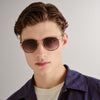 Tortoise shell and gold Le Specs sunglasses on a male model front view