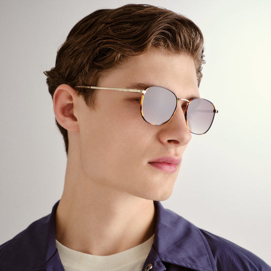 Tortoise shell and gold Le Specs sunglasses on a male model side view
