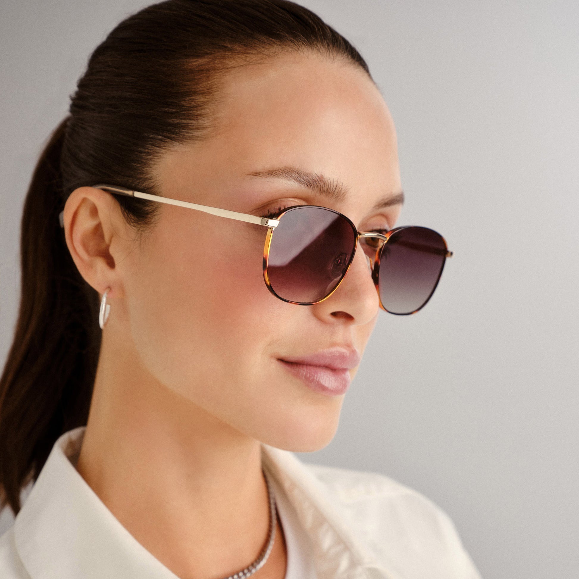 Tortoise shell and gold Le Specs sunglasses on a female model side view