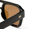 Black Le Specs sunglasses on a white background close up