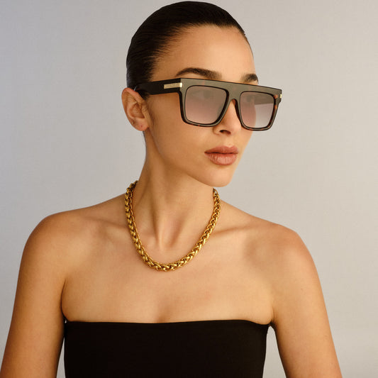 Tortoise shell Le Specs sunglasses on a female model, side view