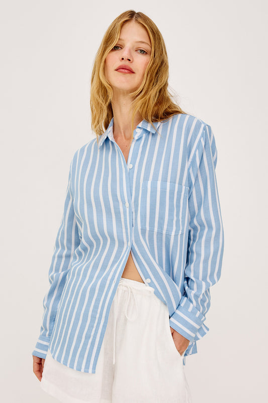 Woman wearing a blue and white Rails shirt striped shirt against a plain background