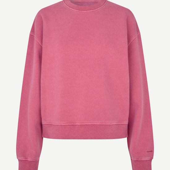 A dusty rose pink crewneck sweatshirt with a relaxed fit, displayed on a clean, light off-white background.