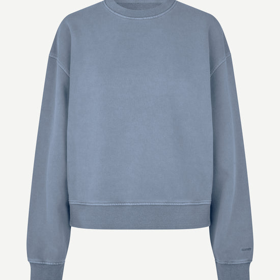 A dusty blue crewneck sweatshirt with a relaxed fit, shown flat against a light off-white background.