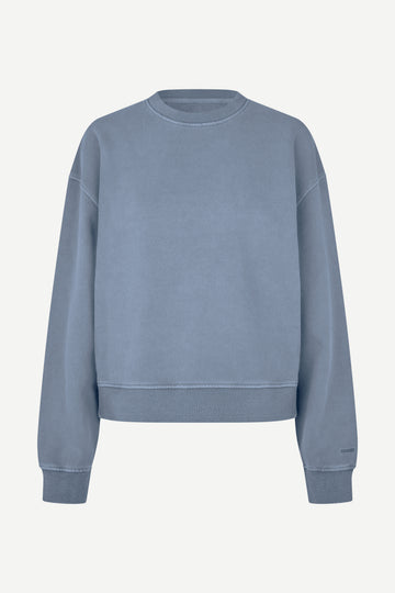 A dusty blue crewneck sweatshirt with a relaxed fit, shown flat against a light off-white background.