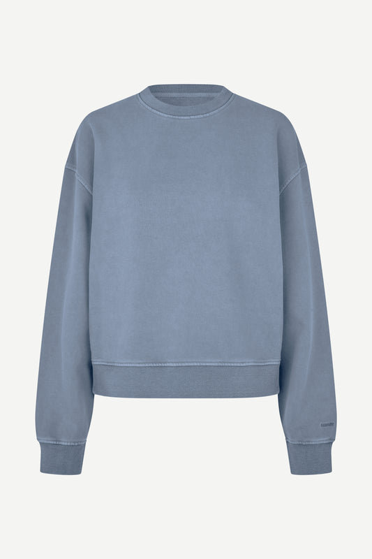 A dusty blue crewneck sweatshirt with a relaxed fit, shown flat against a light off-white background.