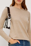 woman wearing beige long sleeve t shirt close up